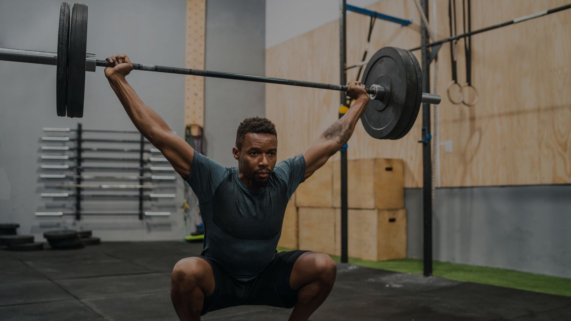 Person lifting a barbell in a gym setting